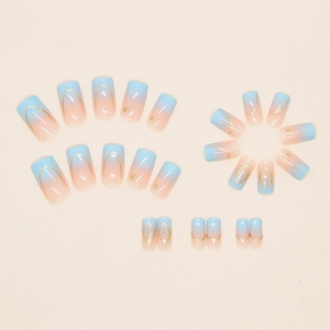 Blue and orange gradient press on nails with gold glitter dots in a 24-piece set
