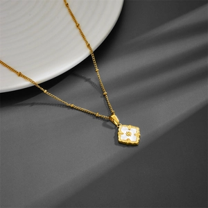 Titanium steel necklace with white four-leaf clover pendant on dark background