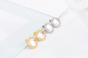 Macro shot of gold and silver stainless steel stud earrings with faceted crystal glass