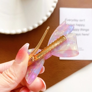 Elegant acetate butterfly hair clip with iridescent lilac finish and golden metal grip