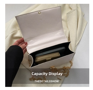Internal view of beige quilted bag holding a smartphone and wallet for storage capacity