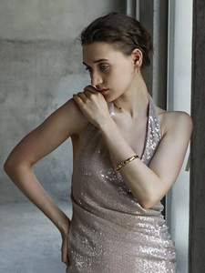 Detail of 18K gold-plated star and moon bangle with crystal insets on model wrist