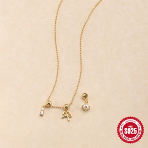 Adjustable S925 sterling silver necklace with bow, pearl and zircon charms on beige paper