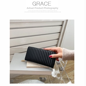 Detailed view of black quilted PU leather long purse with elegant vertical stitching and gold zipper