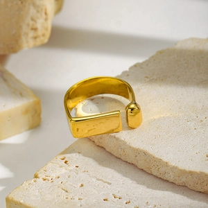 Detailed view of a gold plated irregular geometric open ring on minimalist stone