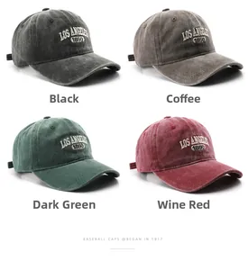Detail of four vintage washed cotton baseball caps in black, brown, dark green, and wine red