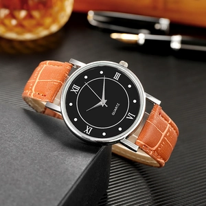 Classic quartz watch with roman numerals and brown leather strap on luxury gift box context