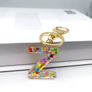Detail of a transparent resin letter Z keychain with colorful heart-shaped sequins inside
