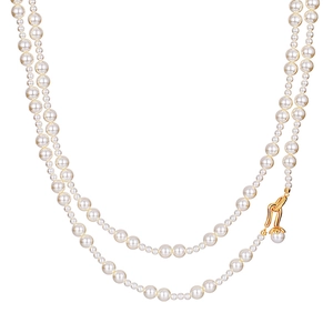 Elegant double-layer faux pearl necklace with a vintage golden metal clasp on white background