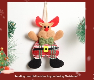 Detail of Christmas reindeer plush ornament with red green stripes and burlap bow
