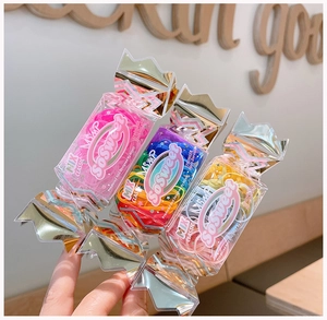 Close-up of durable jelly colored hair ties in a candy-shaped portable container