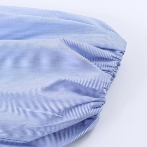 Detailed close-up of blue and white striped poplin fabric with elastic gathered cuffs