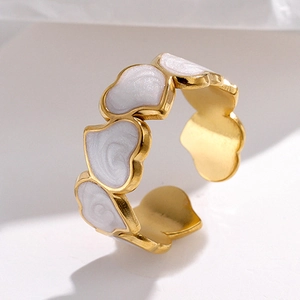 Detail of adjustable gold ring with continuous white enamel heart-shaped drip patterns