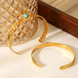 Detail showing vintage gold stainless steel bracelets with turquoise and leaf texture