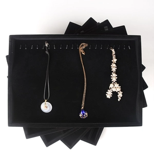 Multi-tier black velvet jewelry display trays for necklaces and rings presentation