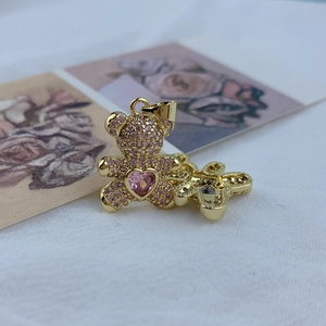 Golden teddy bear pendant with pink cubic zirconia and heart gemstone for women