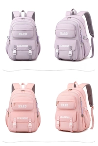 Detail view of pink and purple nylon backpacks with Hard Learning lettering and side pockets