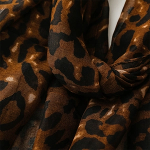 Close-up of leopard print cotton-linen scarf showing fabric texture and soft brown pattern