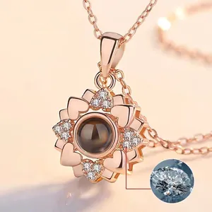 Detail of rose gold sunflower projection necklace with heart petals and white zircons