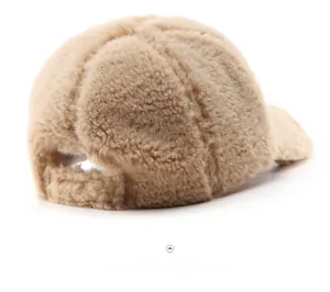Rear view of light beige plush baseball cap showing warm fleece texture and back strap