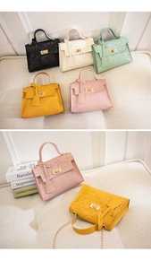 Detailed view of colorful Kelly bags featuring playful cartoon embossing and chain strap