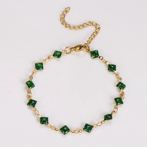 Golden chain bracelet with green glitter charms, lobster clasp and extender detail