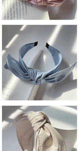 Detailed view of pleated PU leather bow headbands in pink, blue, and beige colors