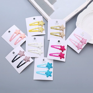 Glittering star-shaped hair clips for girls in vibrant colors on a display card