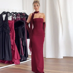 Detailed view of burgundy strapless dress with matching neck wrap and sheer mesh sleeves