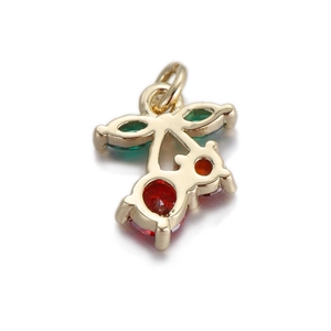 Detailed view of a gold cherry pendant with red and green gemstone embellishments