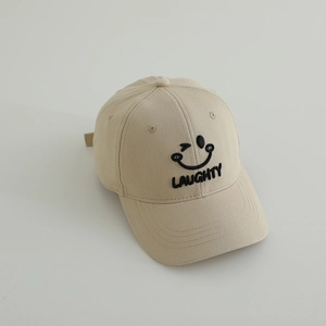 Close-up of beige cotton baseball cap featuring black embroidered smiley face and text