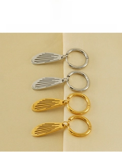 Detail of 18K gold and silver wing earrings showing vacuum plating and color retention