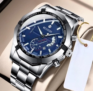 Macro detail of men's blue sunray dial watch with silver stainless steel link bracelet