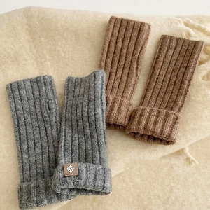 Winter wool knitted fingerless gloves in grey and brown colors with ribbed cuffs