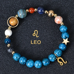 Macro detail of the Leo zodiac charm and 8mm solar system planetary beads bracelet