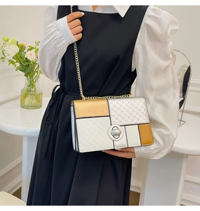 Detail of color-block chain shoulder bag with diamond lattice pattern and metal lock