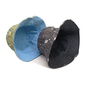 Distressed denim bucket hat with frayed edges and double-sided reversible design