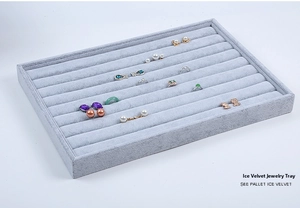 Detailed 45-degree angle of light grey velvet jewelry tray for rings and earrings