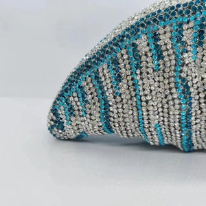 Macro view of blue and white rhinestone encrusted surface on luxury clutch bag