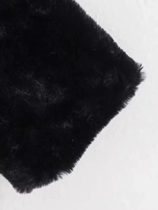 Macro shot showing the dense and soft texture of black faux fur on a flight jacket