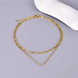 Close-up of golden stainless steel triple-layered chain with rectangle links and K18 tag