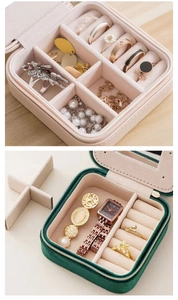 Detail view of pink leather and green velvet jewelry boxes with mirrors and dividers