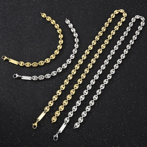 Macro view of gold and silver pig nose link chains with lobster clasps and metal tags