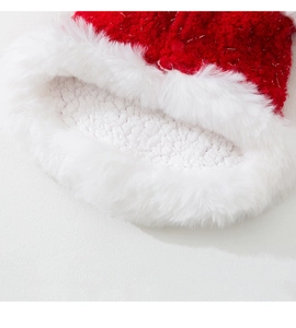 Detailed close-up of festive red velvet pet hat with silver tinsel and soft fleece lining