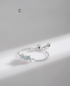 Detailed macro view of S925 sterling silver heart ring with three zircon stones and chain