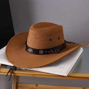 Detail of a brown cowboy hat featuring a leather band with vintage metal ornaments