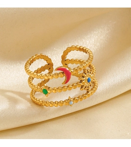 Macro detail of multi-layer gold beaded ring with colorful enamel celestial sun and moon