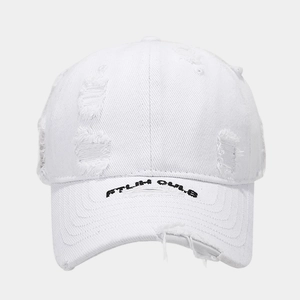Close-up of white distressed baseball cap with embroidery and vintage torn details