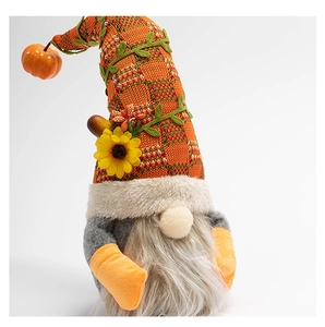 Detailed close-up of an autumn gnome plush featuring a knit hat and pumpkin accent