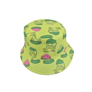 Detail of vibrant green bucket hat with cartoon frog and lotus print patterns